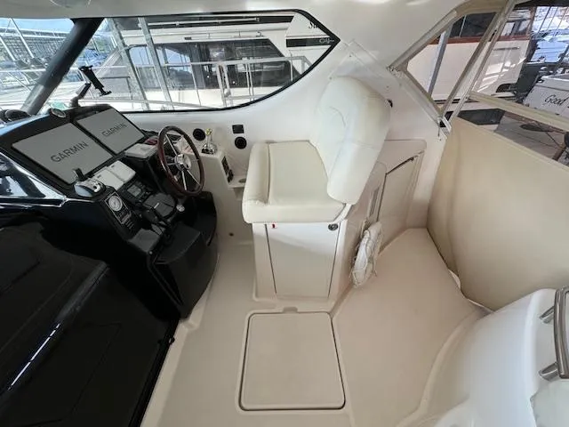 Slide: The Image of 2007 Tiara Yachts 4300 Sovran helm with Garmin navigation and white captain's chair. - 14
