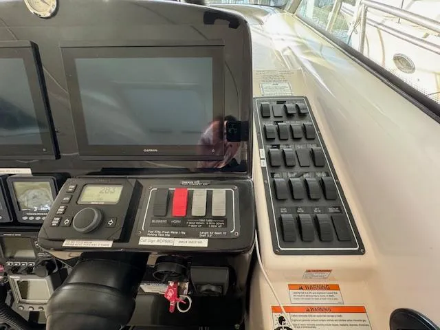 Slide: The Image of Control panel of a 2007 Tiara Yachts 4300 Sovran with navigation screens and switches. - 26