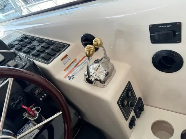 Slide: The Image of Control panel of a 2007 Tiara Yachts 4300 Sovran with steering wheel and throttle levers. - 27