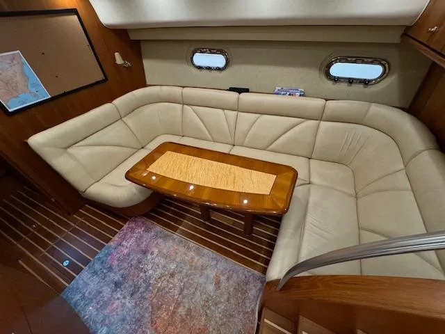Slide: The Image of 2007 Tiara Yachts 4300 Sovran interior with beige seating and wooden table. - 30