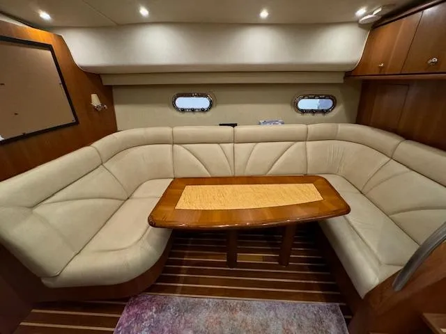 Slide: The Image of Luxurious interior of 2007 Tiara Yachts 4300 Sovran with plush seating and elegant wood table. - 31