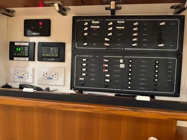 Slide: The Image of Electrical control panel inside 2007 Tiara Yachts 4300 Sovran, featuring switches and displays. - 35