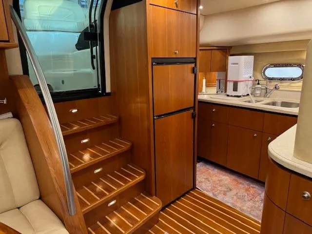 Slide: The Image of Interior of 2007 Tiara Yachts 4300 Sovran, featuring wooden cabinetry and stairs. - 36