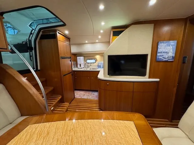 Slide: The Image of 2007 Tiara Yachts 4300 Sovran interior with wood finish, TV, and kitchenette. - 38