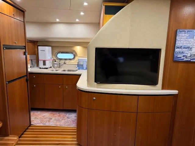 Slide: The Image of 2007 Tiara Yachts 4300 Sovran interior with kitchen, cabinets, and mounted TV. - 39