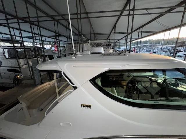 Slide: The Image of 2007 Tiara Yachts 4300 Sovran docked in a covered marina. - 4