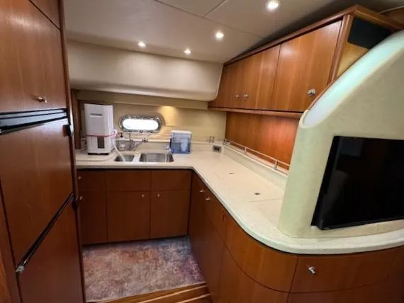 Slide: The Image of 2007 Tiara Yachts 4300 Sovran kitchen with wood cabinets and modern appliances. - 42
