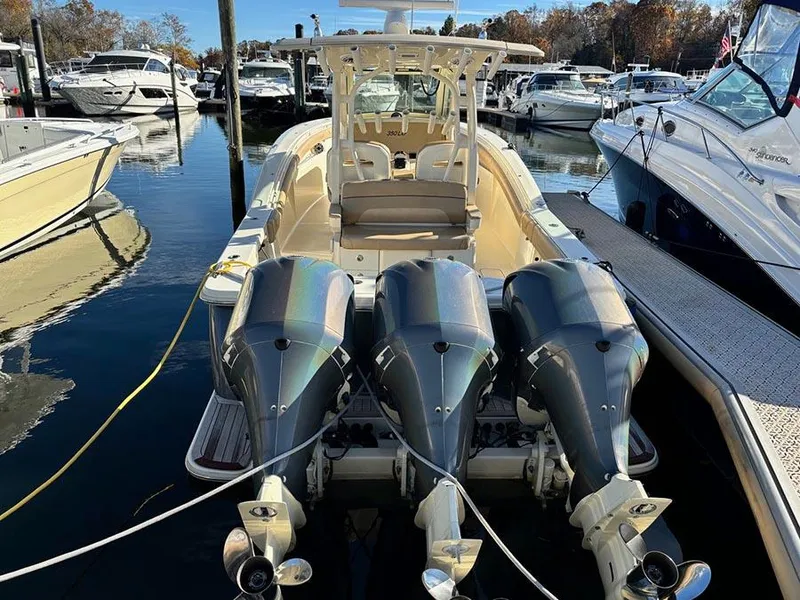 Slide: The Image of 2016 Scout 350 LXF boat with triple engines docked at marina. - 1