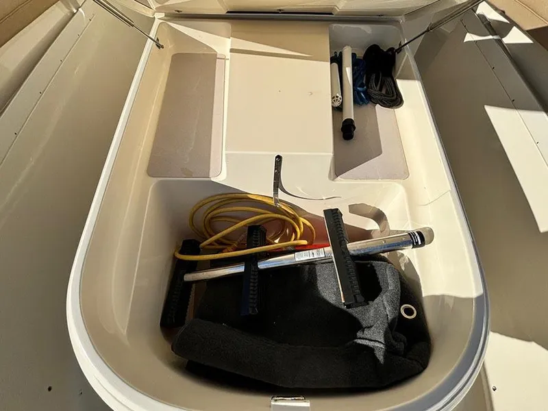 Slide: The Image of Storage compartment of 2016 Scout 350 LXF boat with various equipment. - 17