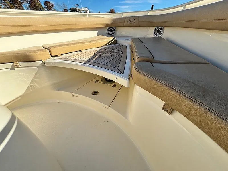 Slide: The Image of 2016 Scout 350 LXF boat interior with cushioned seating and deck. - 21