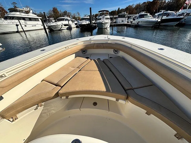 Slide: The Image of 2016 Scout 350 LXF boat with cushioned seating, docked in a marina. - 22