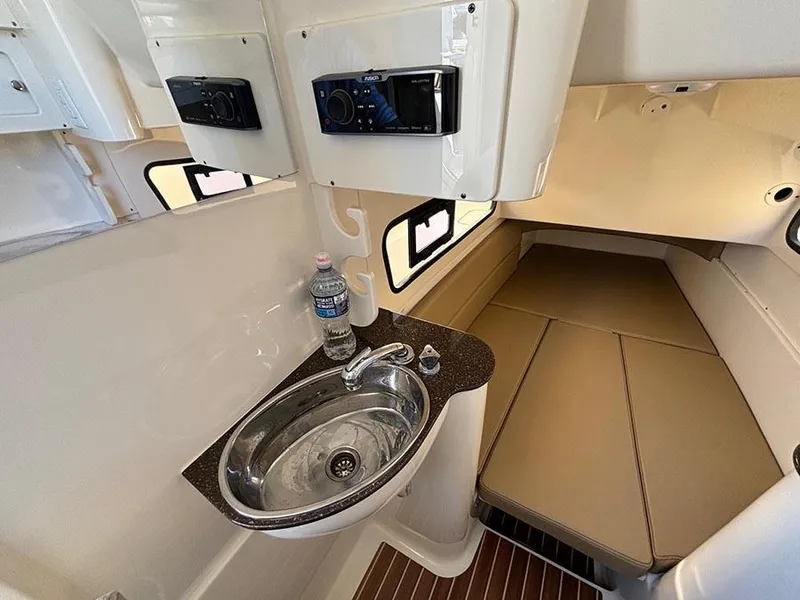 Slide: The Image of 2016 Scout 350 LXF cabin interior with sink, bed, and storage compartments. - 28