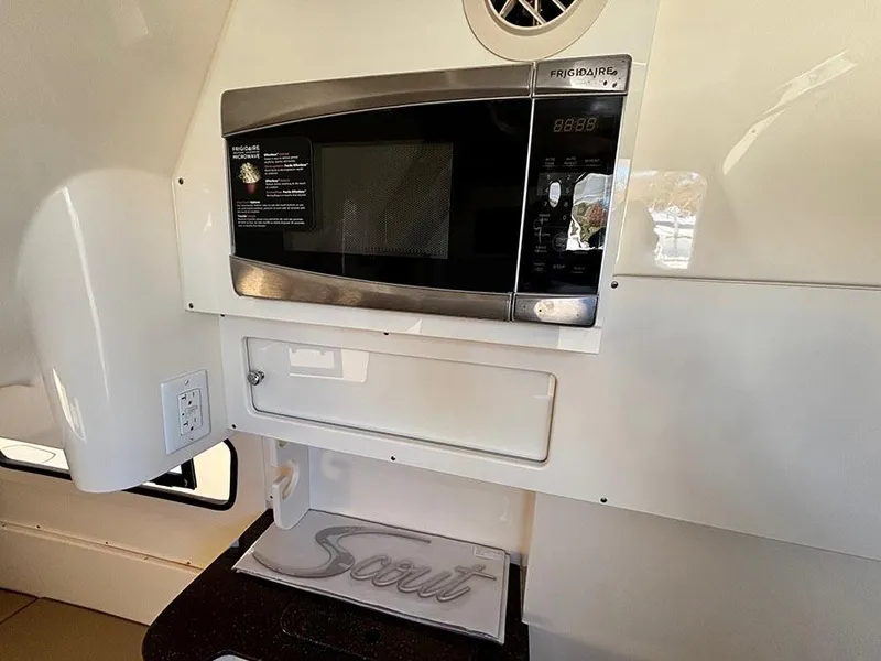 Slide: The Image of 2016 Scout 350 LXF interior with Frigidaire microwave and branded towel. - 29