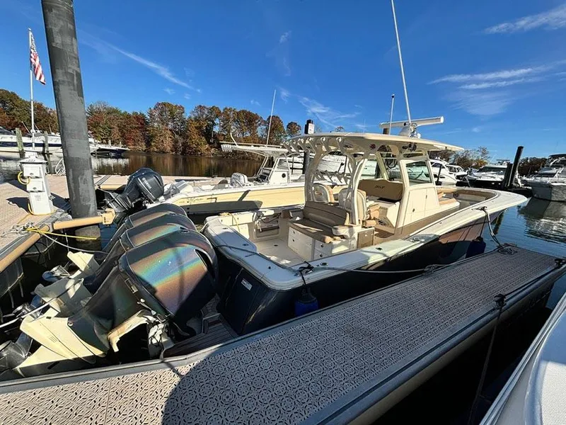 Slide: The Image of 2016 Scout 350 LXF boat docked at marina with triple outboard engines. - 3