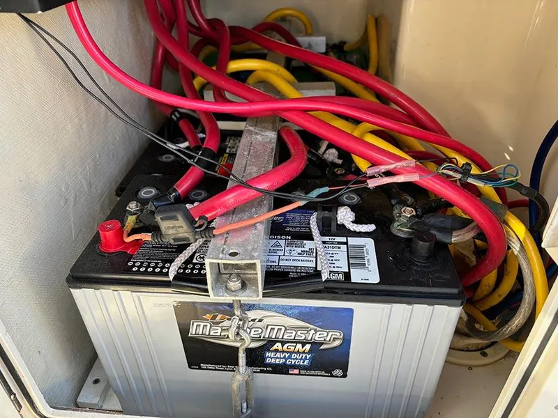 Slide: The Image of Marine battery with red and yellow cables in a 2016 Scout 350 LXF boat. - 33