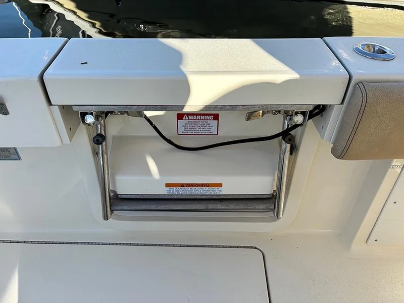 Slide: The Image of 2016 Scout 350 LXF boat swim platform with ladder and warning label. - 34