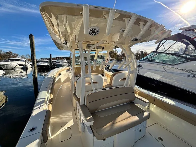 Slide: The Image of 2016 Scout 350 LXF boat docked, featuring spacious seating and sleek design. - 36