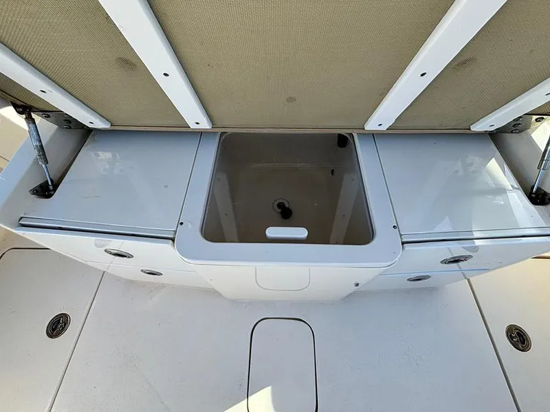 Slide: The Image of 2016 Scout 350 LXF boat storage compartment with open lid. - 8