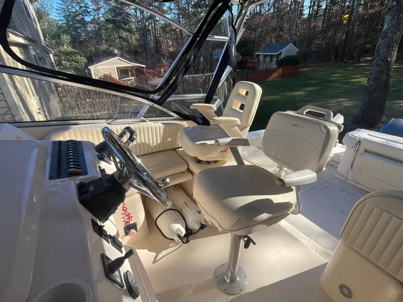 Slide: The Image of 2003 Grady-White 330 Express boat interior with helm and seating area. - 11