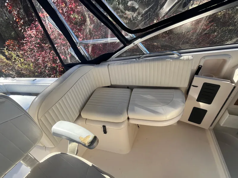 Slide: The Image of 2003 Grady-White 330 Express boat interior with white cushioned seating. - 12