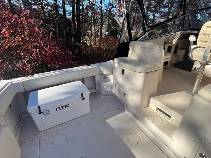 Slide: The Image of 2003 Grady-White 330 Express boat interior with seating and RTIC cooler. - 13