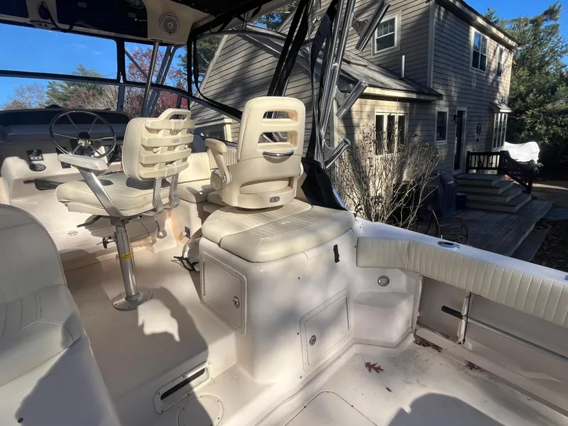 Slide: The Image of 2003 Grady-White 330 Express boat interior with seating and steering wheel. - 14