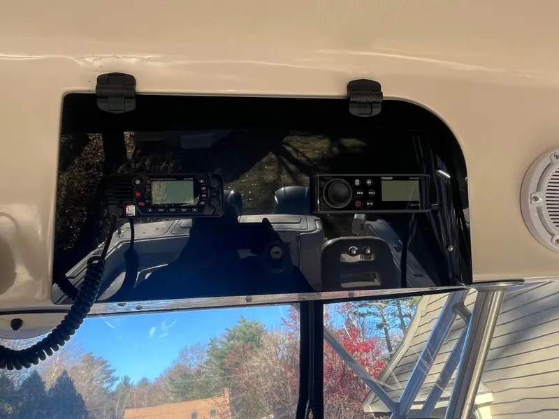 Slide: The Image of 2003 Grady-White 330 Express boat dashboard with radio and navigation equipment. - 16