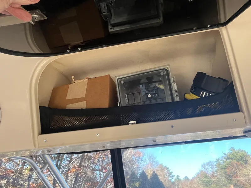 Slide: The Image of Storage compartment in 2003 Grady-White 330 Express boat with various items. - 17
