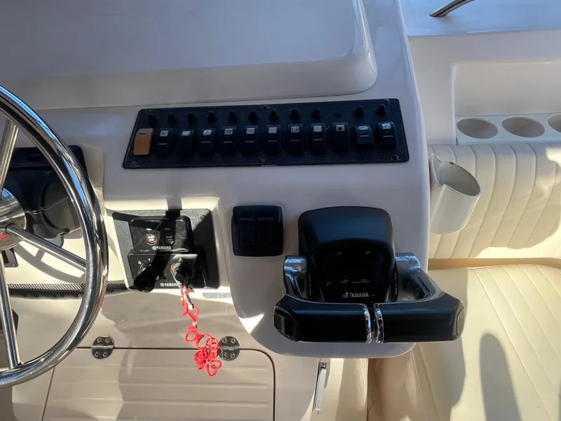 Slide: The Image of 2003 Grady-White 330 Express boat dashboard with controls and steering wheel. - 22