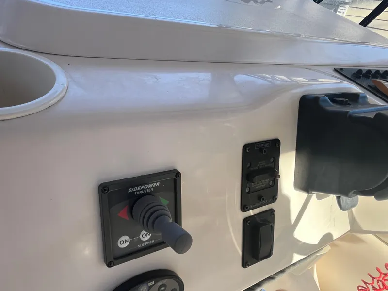 Slide: The Image of Control panel of 2003 Grady-White 330 Express boat with switches and joystick. - 23