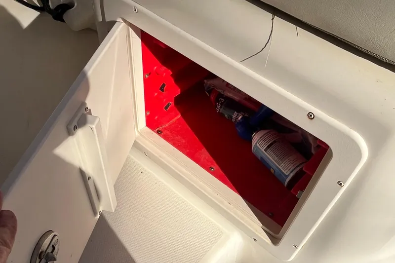 Slide: The Image of Open storage compartment on 2003 Grady-White 330 Express boat with red interior. - 24