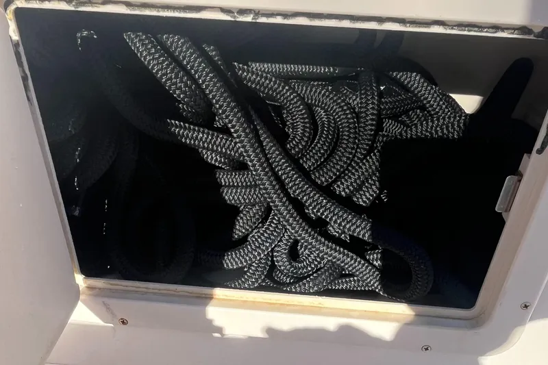 Slide: The Image of Coiled ropes in storage compartment of 2003 Grady-White 330 Express boat. - 30