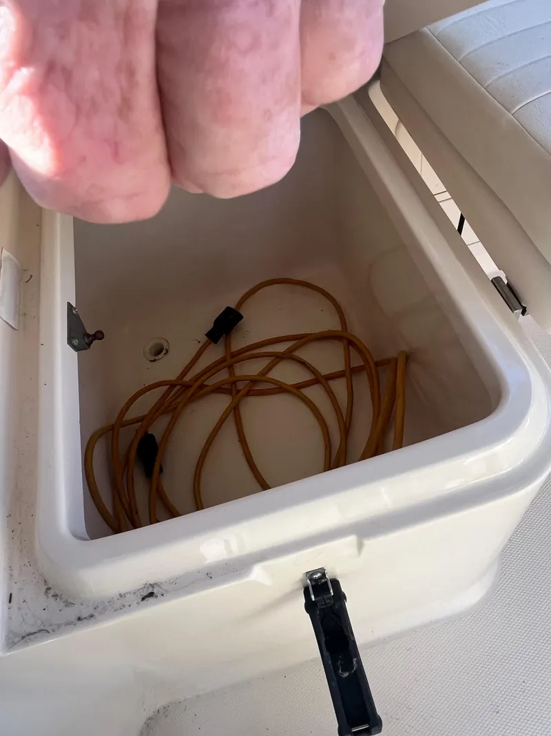 Slide: The Image of Open storage compartment on 2003 Grady-White 330 Express boat with coiled cables inside. - 32