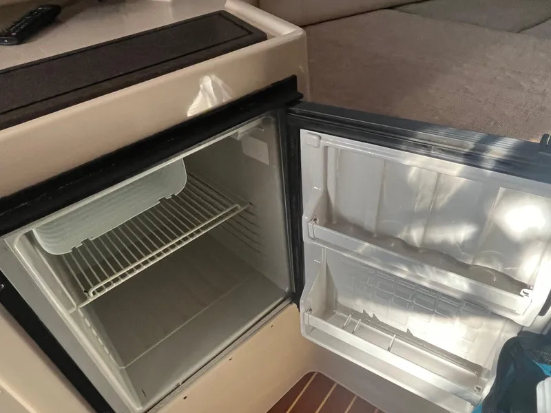 Slide: The Image of Open mini fridge inside 2003 Grady-White 330 Express boat cabin. - 36