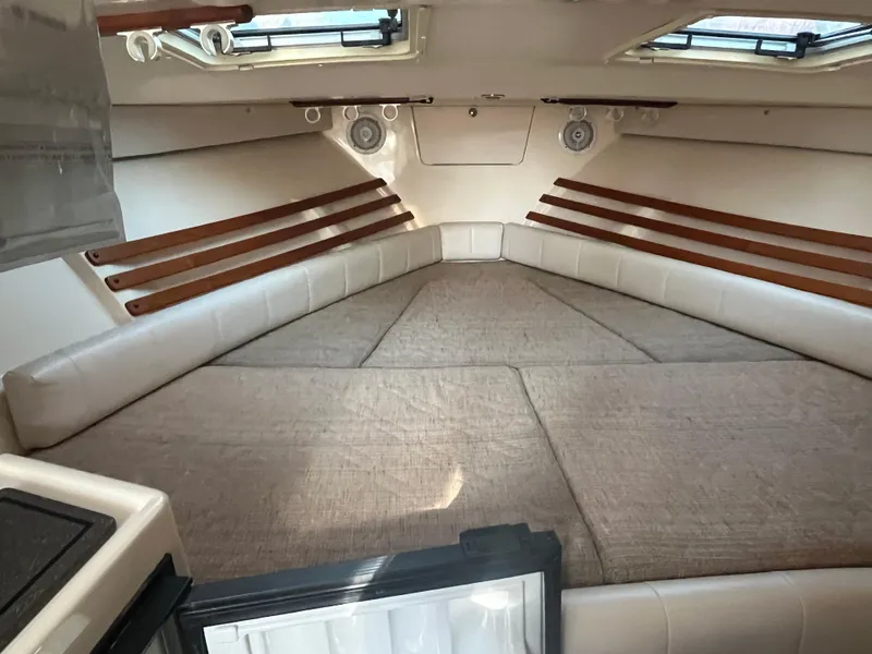 Slide: The Image of Interior cabin of 2003 Grady-White 330 Express boat with beige cushions and wooden accents. - 37