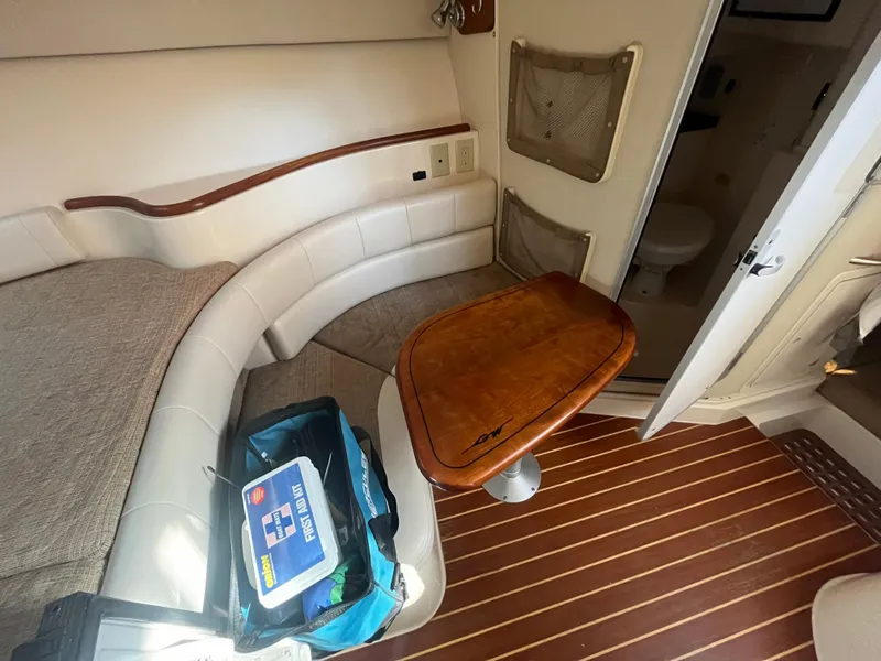 Slide: The Image of Interior of 2003 Grady-White 330 Express boat with seating and wooden table. - 38