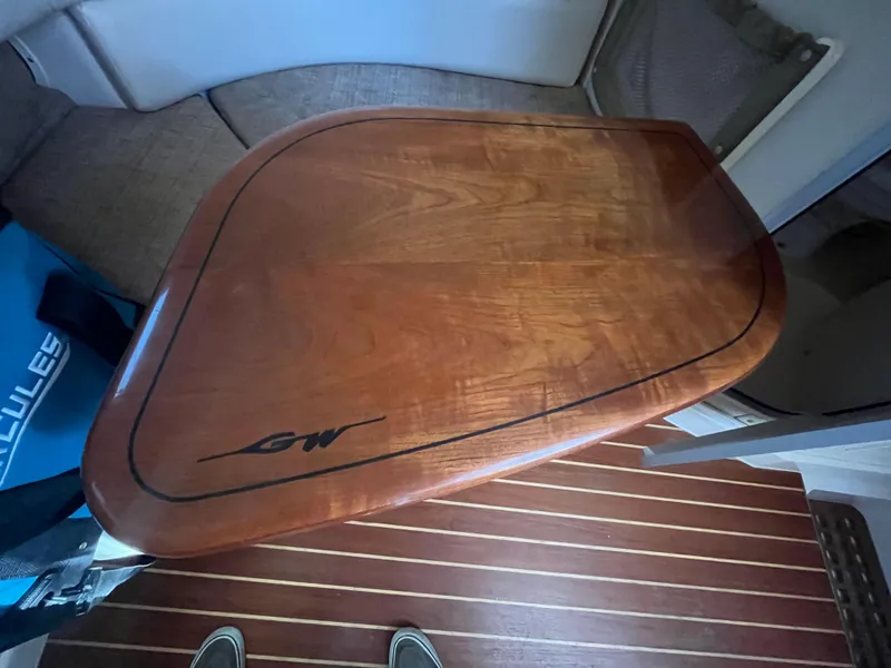 Slide: The Image of Wooden table inside 2003 Grady-White 330 Express boat cabin. - 39