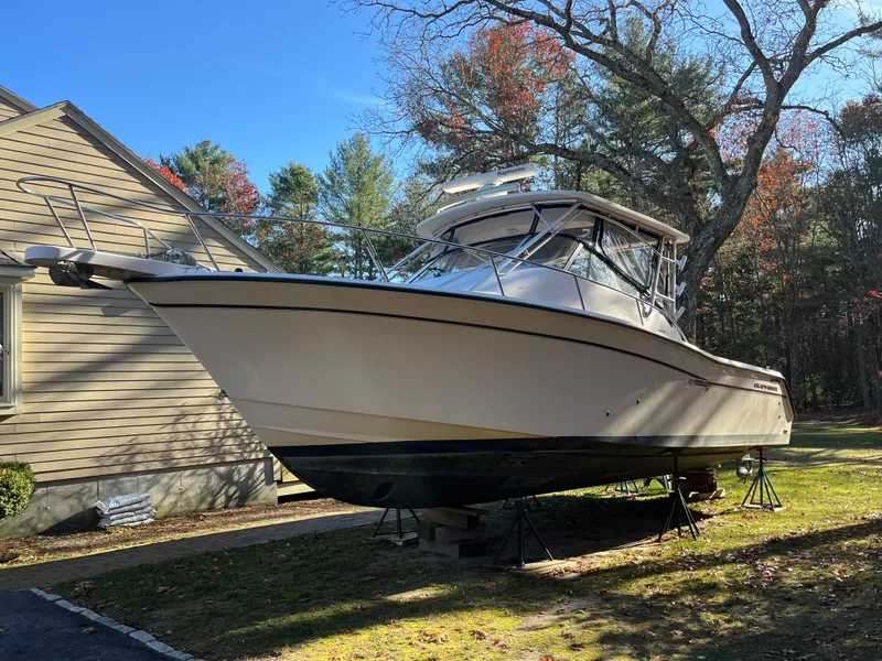 Slide: The Image of 2003 Grady-White 330 Express boat on stands, outdoors, near a house. - 4