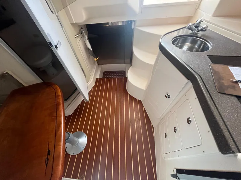 Slide: The Image of Interior of 2003 Grady-White 330 Express boat with wood flooring and compact kitchenette. - 40