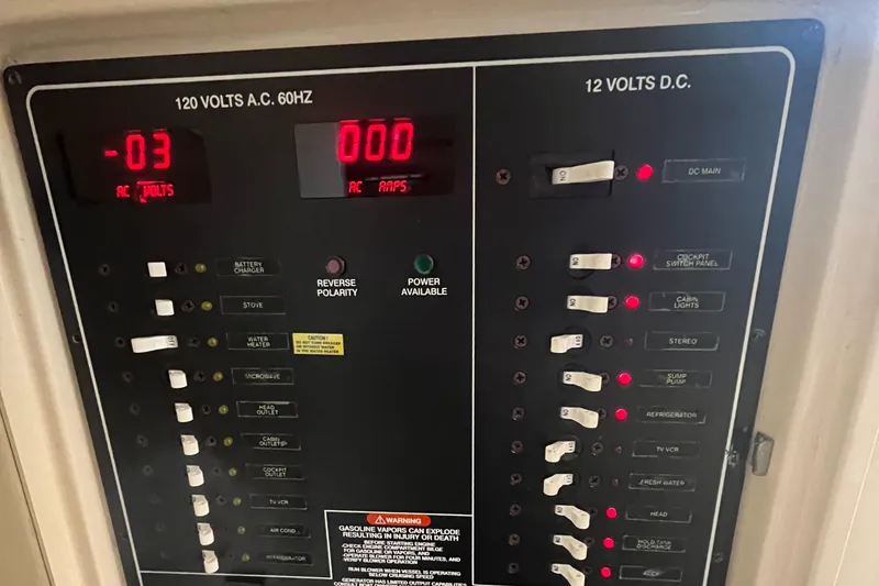 Slide: The Image of Electrical panel of 2003 Grady-White 330 Express boat, showing AC and DC voltage controls. - 41
