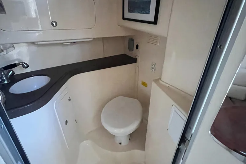 Slide: The Image of 2003 Grady-White 330 Express boat bathroom interior with sink and toilet. - 43
