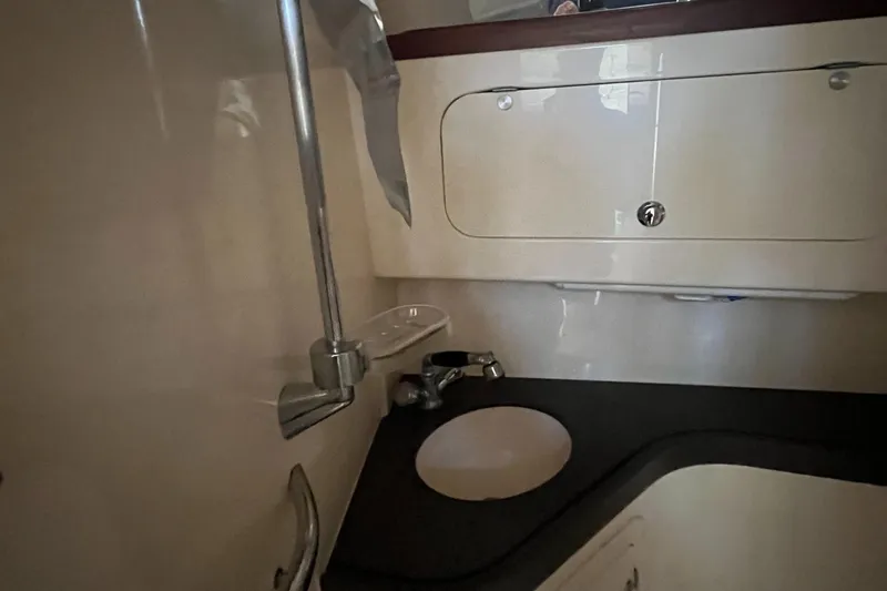 Slide: The Image of 2003 Grady-White 330 Express boat bathroom with sink and storage. - 46