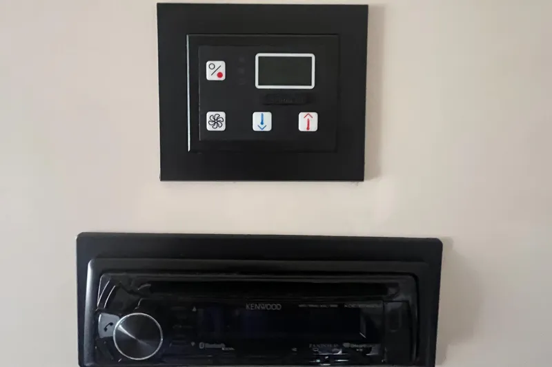 Slide: The Image of Control panel and stereo system on 2003 Grady-White 330 Express boat. - 47