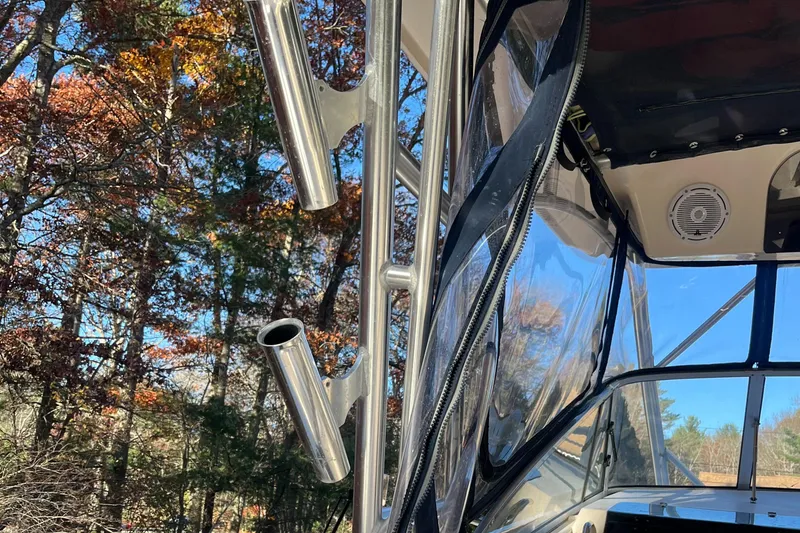 Slide: The Image of 2003 Grady-White 330 Express boat with rod holders, surrounded by autumn trees. - 48