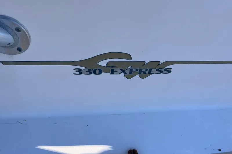 Slide: The Image of Grady-White 330 Express 2003 boat logo on white surface. - 49