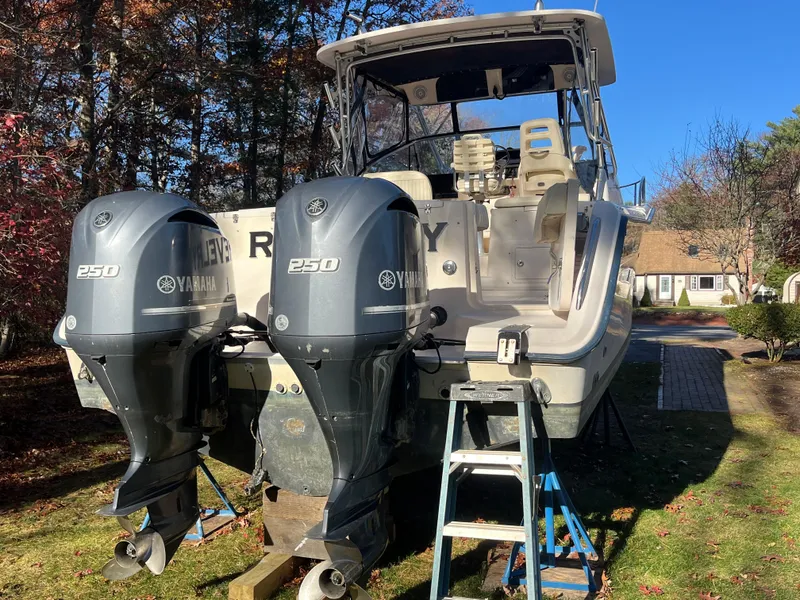 Slide: The Image of 2003 Grady-White 330 Express boat with twin Yamaha 250 engines on land. - 5