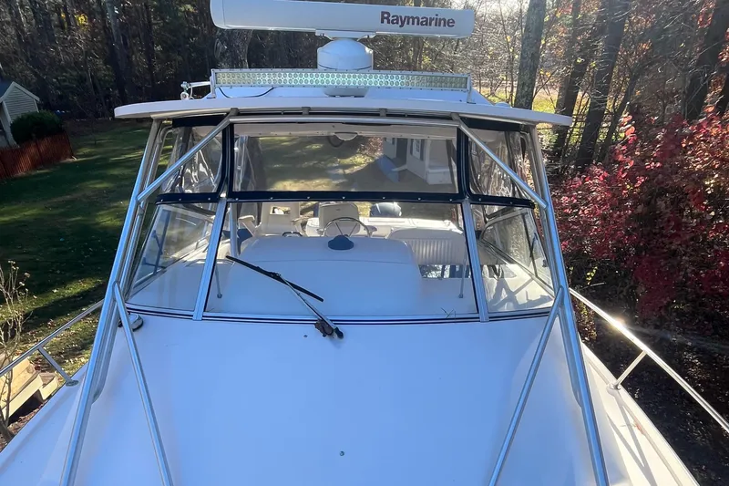 Slide: The Image of 2003 Grady-White 330 Express boat with Raymarine equipment, docked in a wooded area. - 52