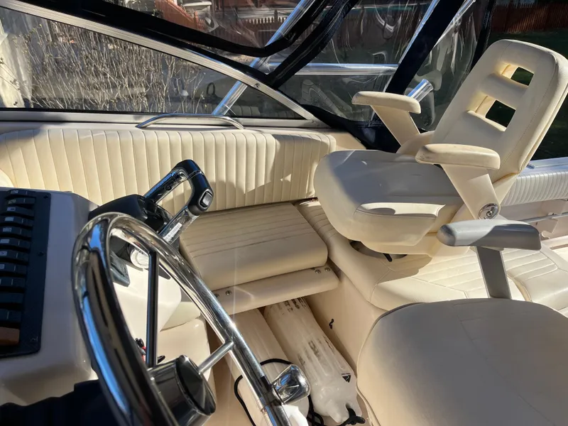 Slide: The Image of Interior of 2003 Grady-White 330 Express boat with steering wheel and seating. - 8