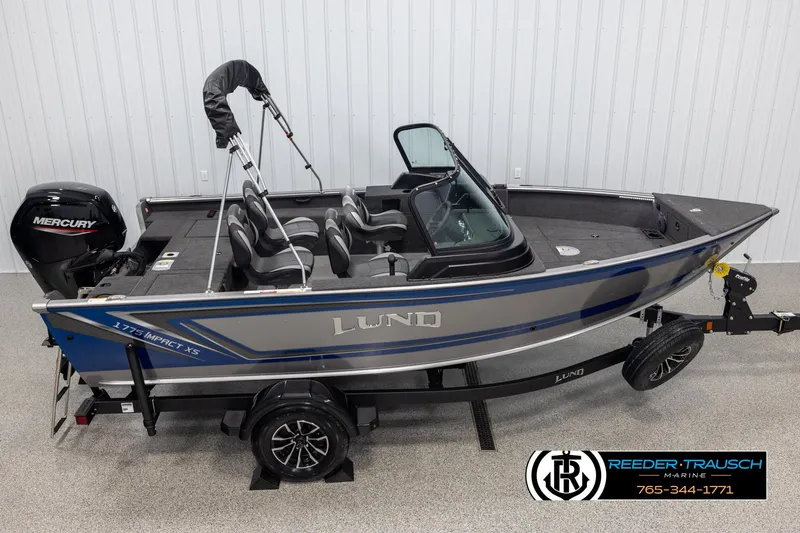 Slide: The Image of 2025 Lund 1775 Impact XS fishing boat with Mercury engine on trailer. - 1