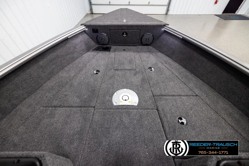 Slide: The Image of 2025 Lund 1775 Impact XS boat interior with carpeted deck and storage compartments. - 15